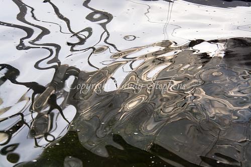Contemporary color photograph of soft gray reflections, enhancing decor with understated elegance and capturing fluid motion, presented authentically by the artist with minimal post-processing.