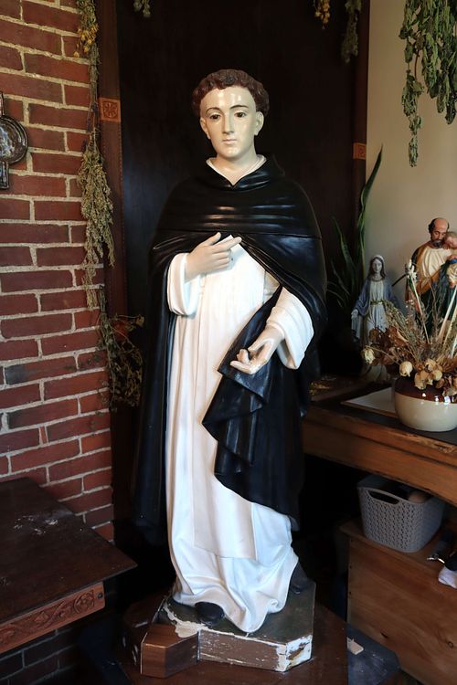 A very pale statue of St. Dominic